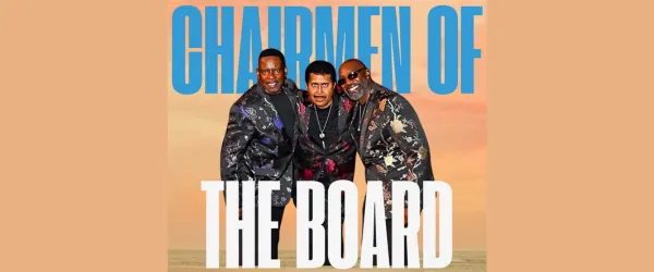 Three men in patterned suits stand together, smiling, with "CHAIRMEN OF THE BOARD" in large blue and white text behind them.