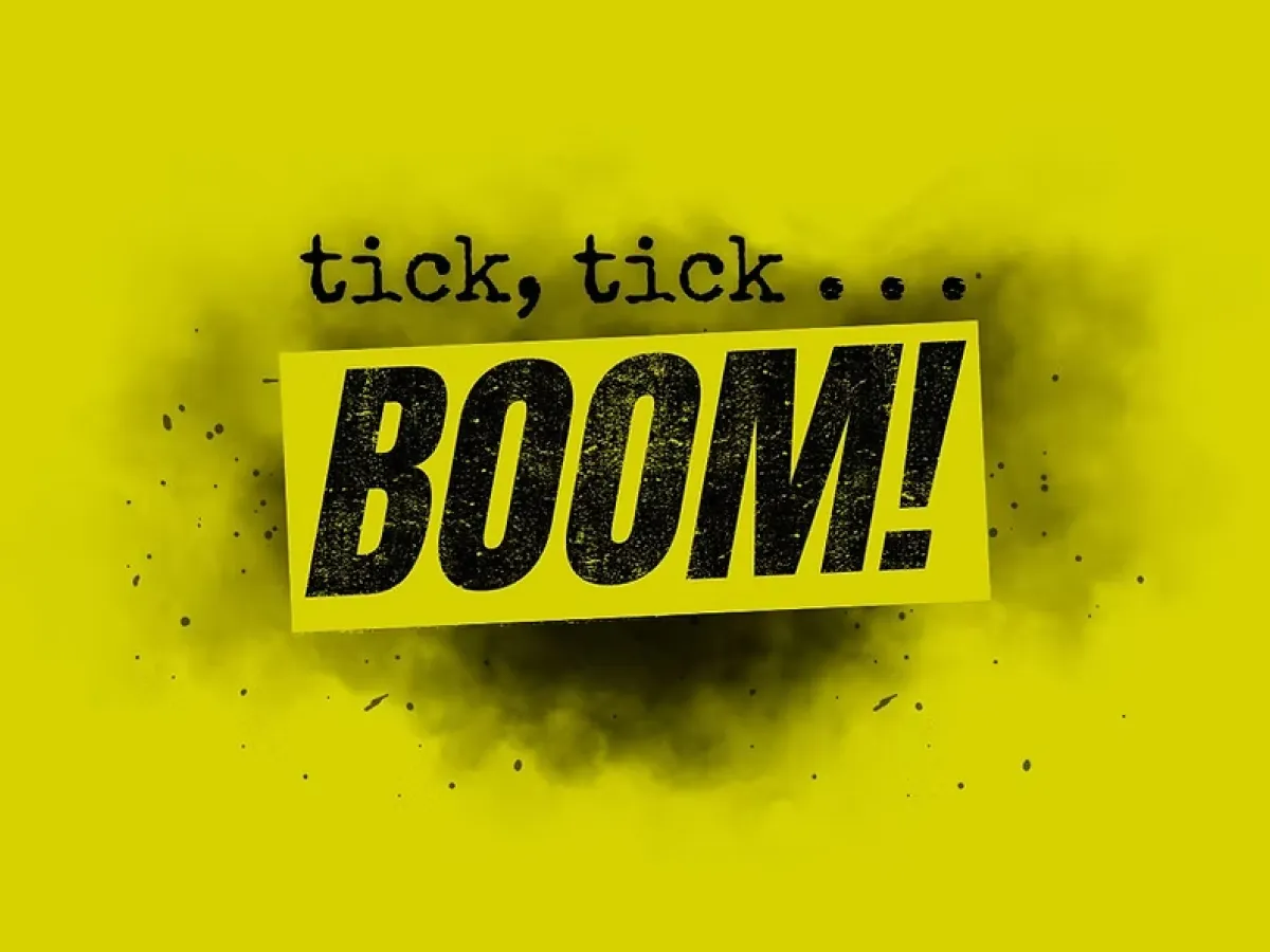 Yellow background with black text: "tick, tick... BOOM!" The word "BOOM!" is bold and prominent.